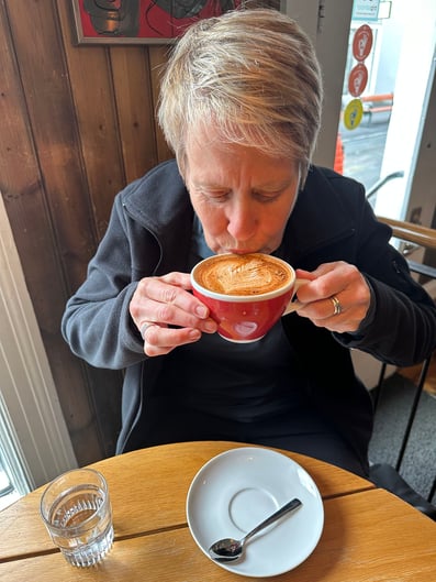 Juli enjoys a much needed latte after a long flight.