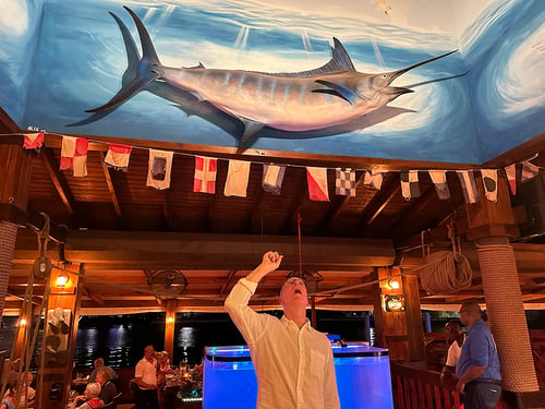 Jim looking up at the huge marlin mounted in Skipjacks