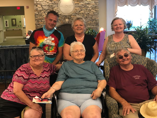 Jacobson siblings in front of fireplace at the rehabilitation center