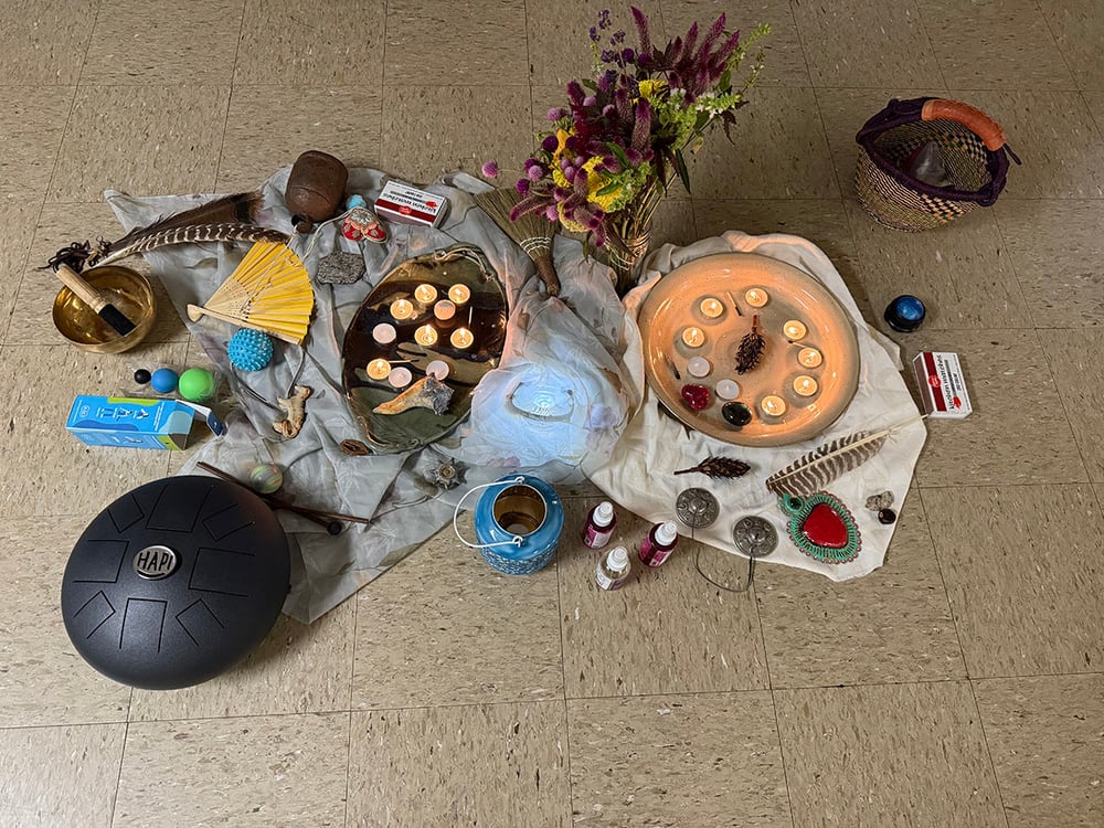 lighted tea candles on the floor surrounded by lots of yoga paraphernalia